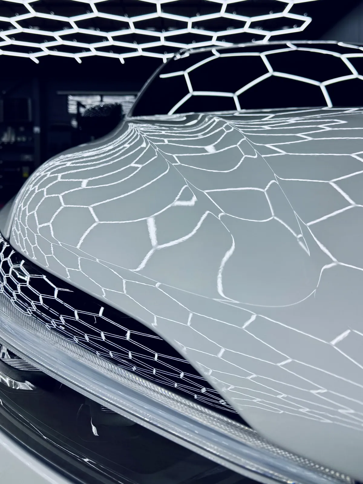 Valkoisen Volvo XC60:n konepelti ja säleikkö lähikuvassa